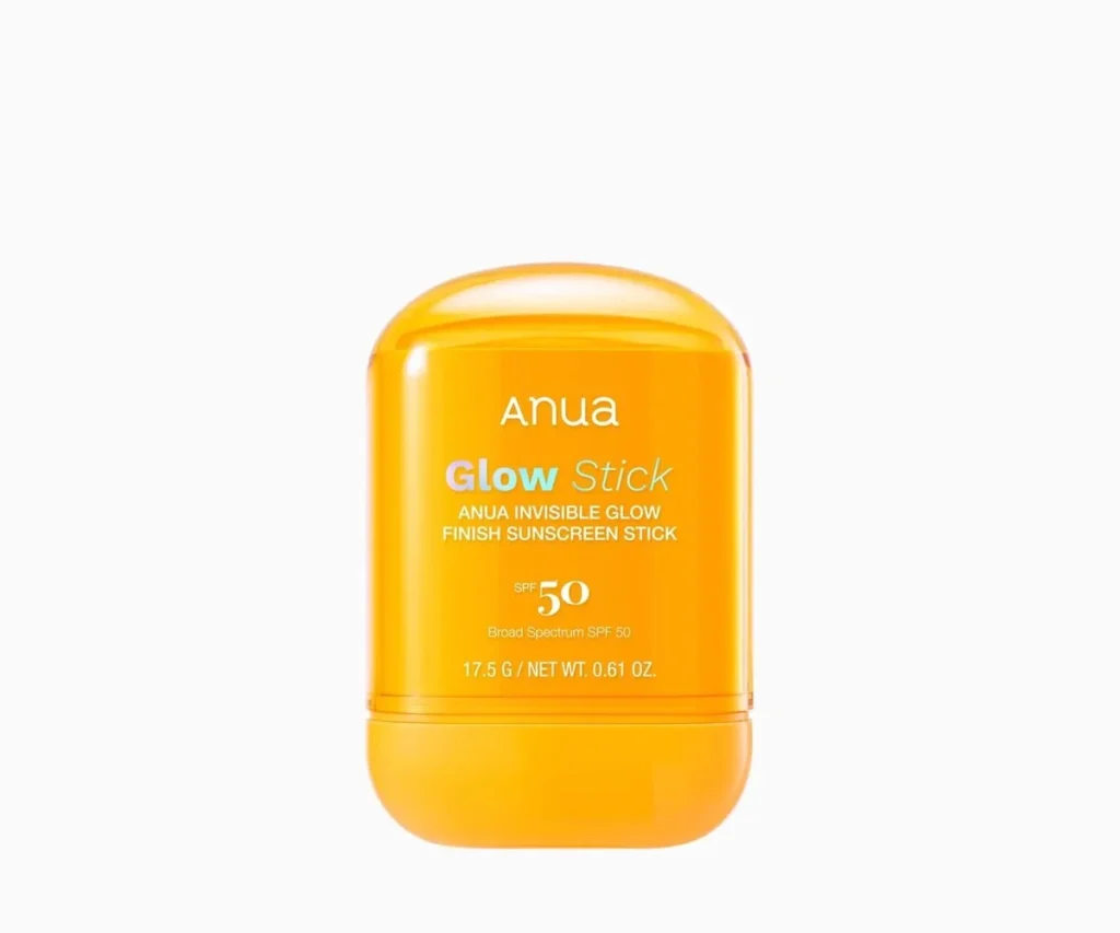 Anua Glow Stick SPF50 sunscreen in its orange twist-up tube