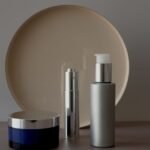 Skincare bottles and moisturizer on a bright vanity table