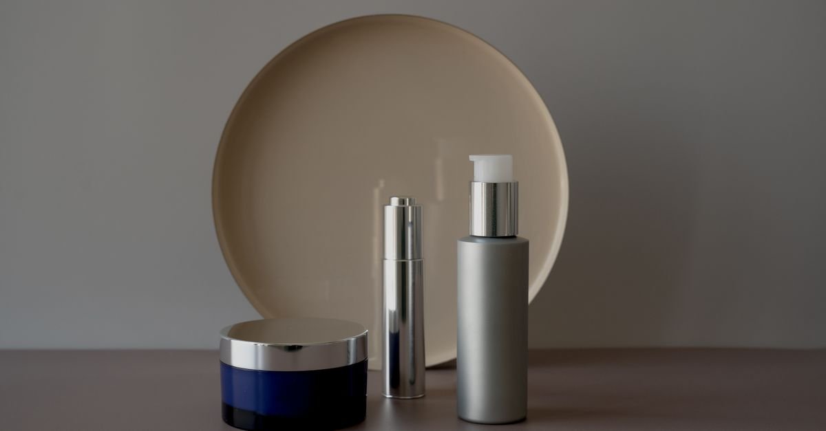 Skincare bottles and moisturizer on a bright vanity table