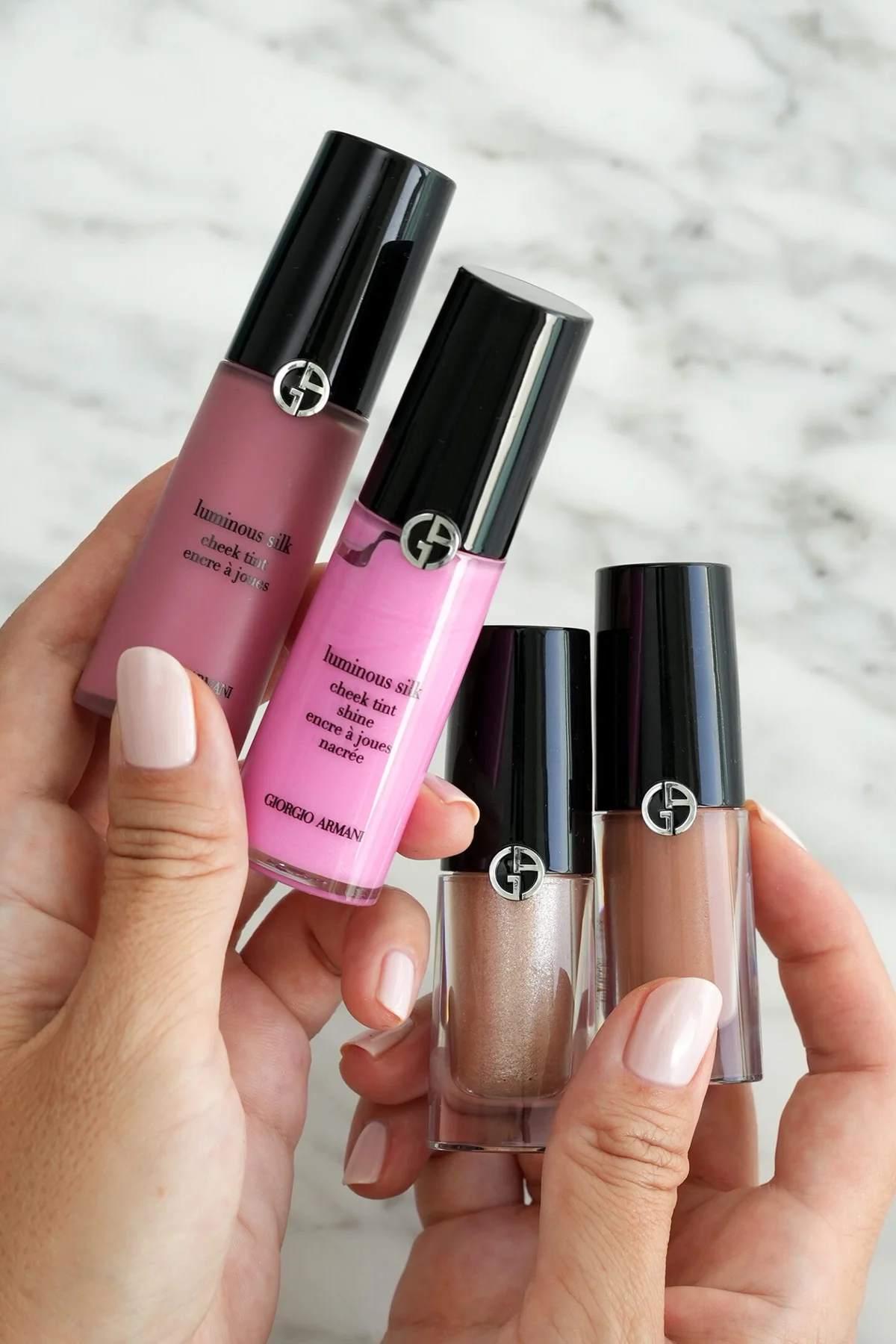 Giorgio Armani Cheek Tint liquid blush bottles held in hand