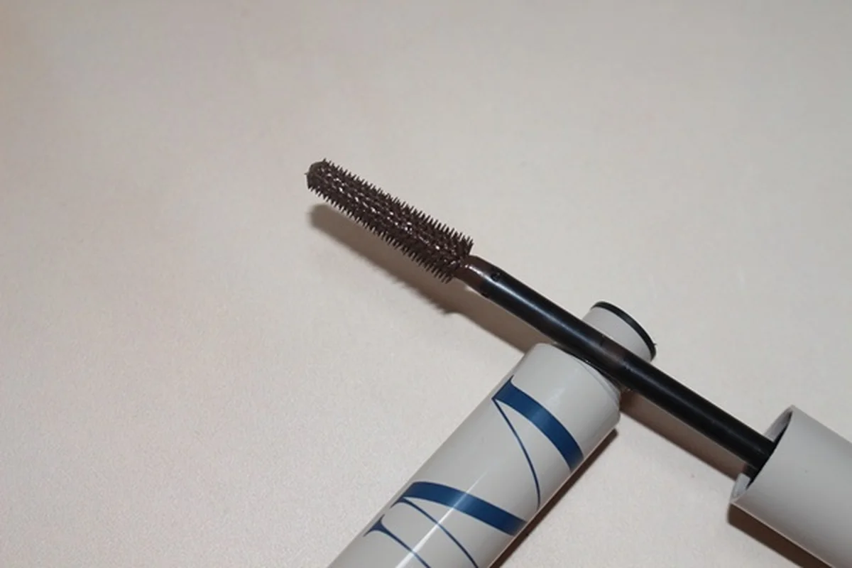RUM Wrap Party mascara wand resting on its tube