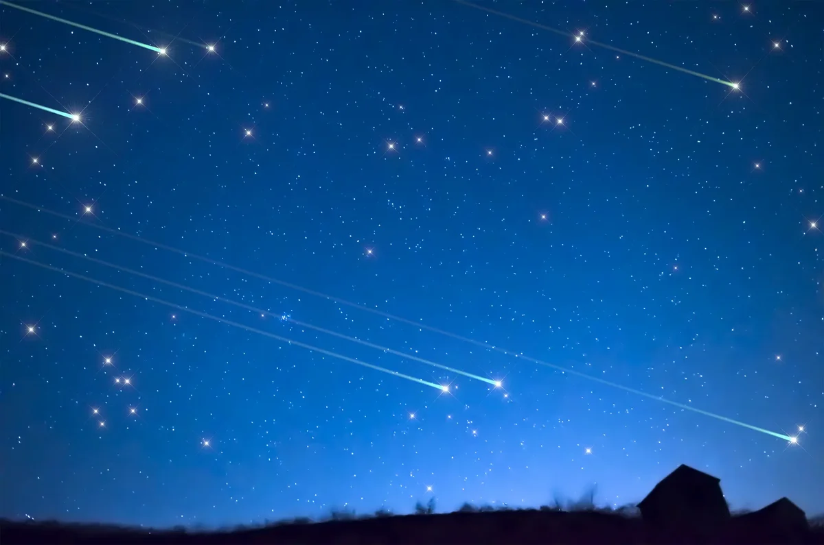 Bright Perseid meteor streaks across a dark August night sky