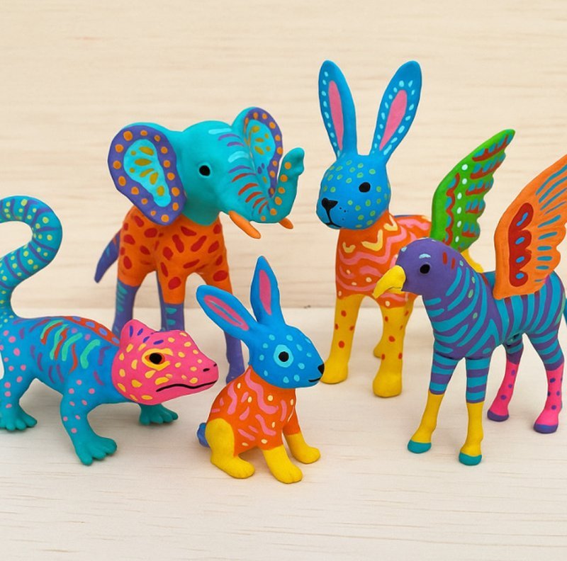 Painted alebrije figures in bright colors on a table