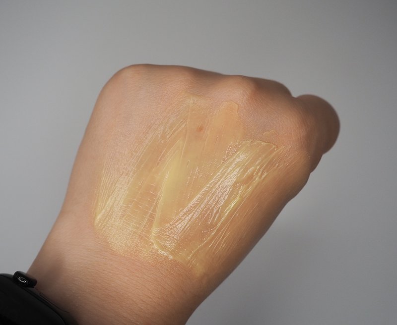 Yellow cream texture smeared on back of hand